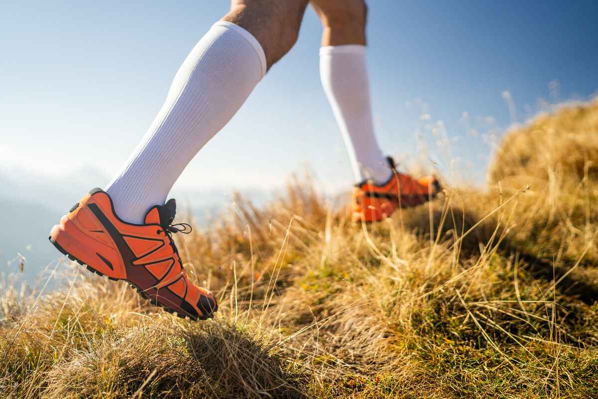 Man wears compression socks to prevent blood clots