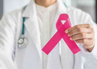 Doctor holds breast cancer awareness ribbon