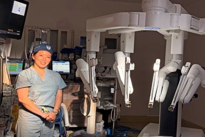 Dr. Michelle Kim with a da Vinci 5 robotic device in the OR at Yale New Haven Hospital.