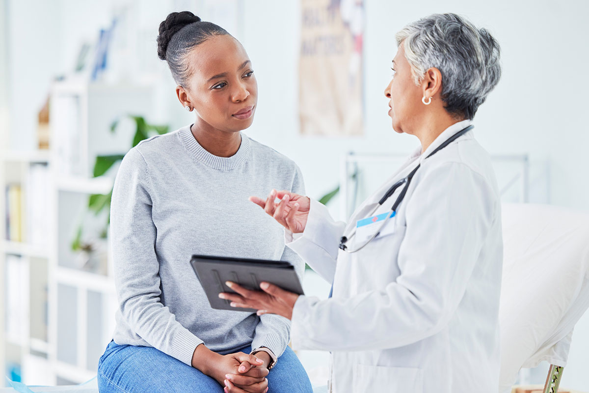 A young adult patient talking with a doctor