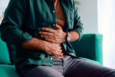 Person with stomach cancer experiencing abdominal pain