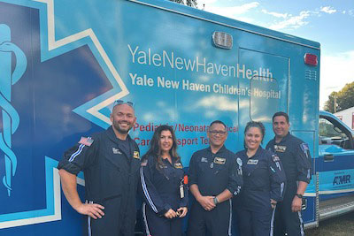 Pediatric team in front of an ambulance
