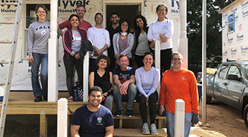 habitat for humanity members on a porch