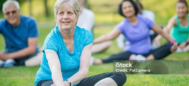 woman stretching in outdoor excercise class